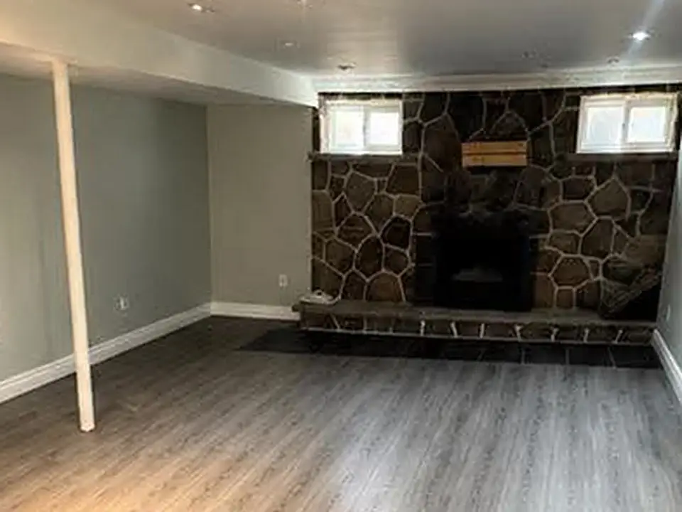 The same finished basement with a clean, clear floor, after cleaning